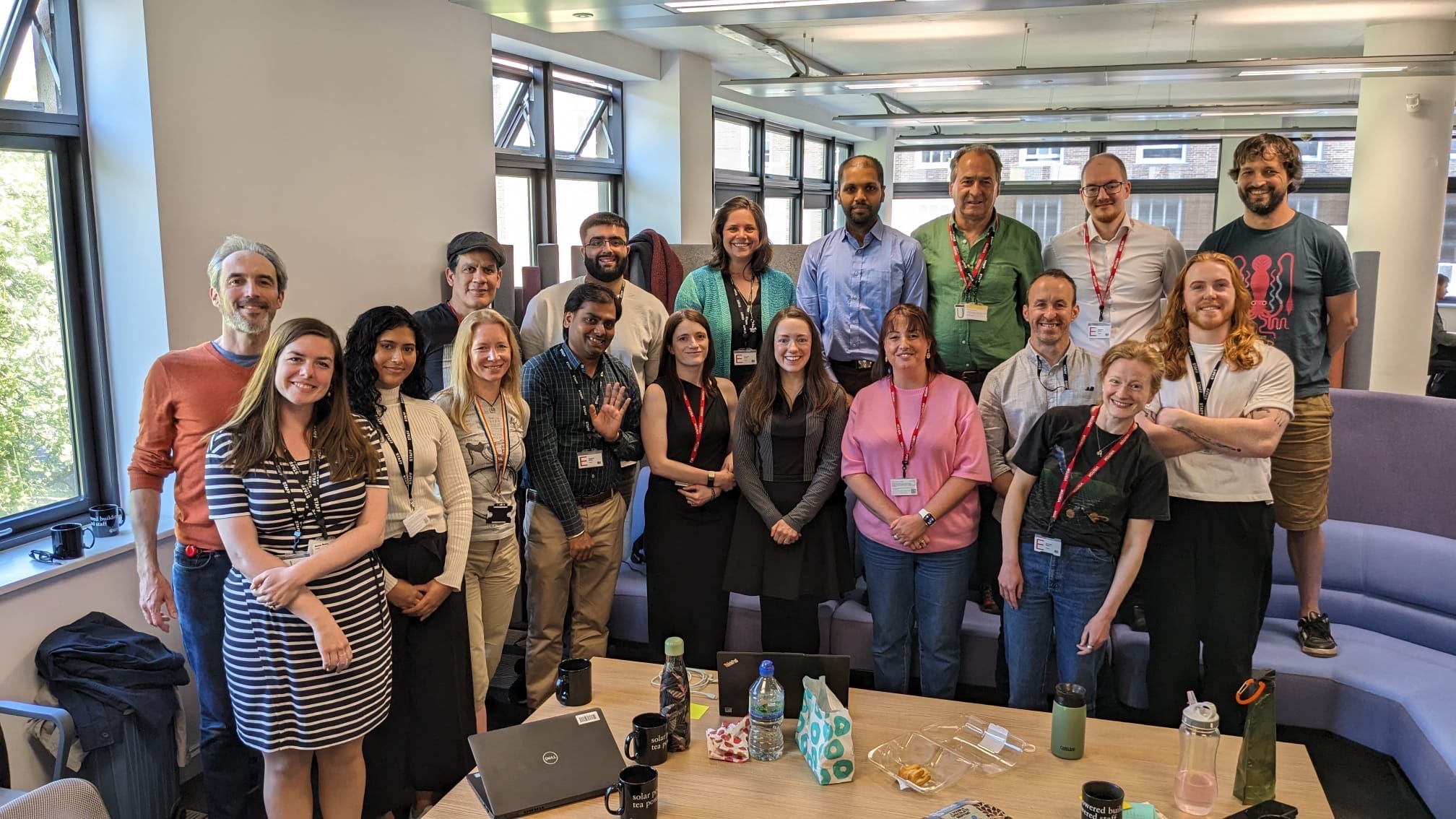 A group of people standing in two rows smiling at the camera